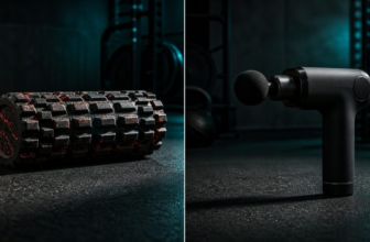 Foam roller and massage gun side by side on a dark gym floor