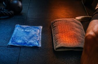 Gel ice pack and warm heating pad side by side on a gym floor