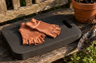 Foam kneeling pad and compression gloves on a wooden garden bench